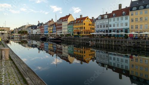 Copenhagen’s iconic harbor facades shimmering with vibrant hues at dawn