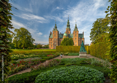 Timeless Rosenborg Castle framed by fresh summer leaves and morning light