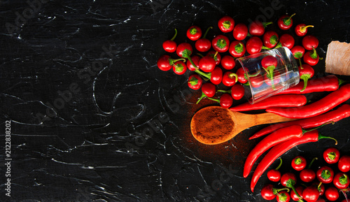 Cuadro en lienzo Vibrant red chili peppers on rustic wooden board with spices and garlic