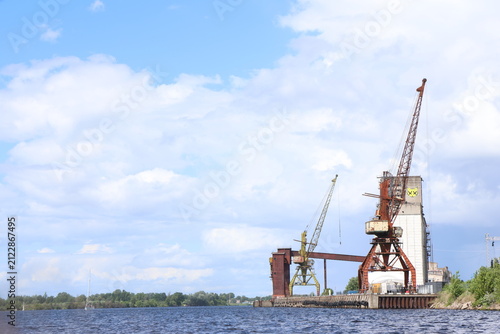 Canvastavla A low-angle view from the river showing an old industrial cargo port