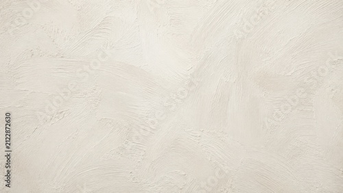 A close up view of a textured off white painted wall surface