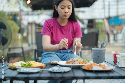 Young woman enjoying a delicious meal at an outdoor restaurant table