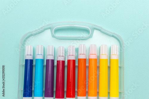 Obraz na płótnie Colorful Markers in Organized Case on Light Blue Background for Creative Project