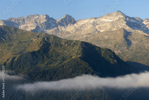 Sunrise lighting Pyrenees mountains and valley fog in Superbagneres