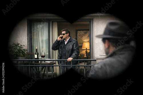 Surveillance of Man Talking on Phone Through Window