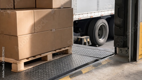 Boxes being unloaded from a truck at a loading dock during daytime