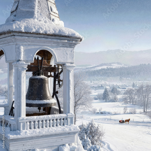 An old church bell, covered with snow, hangs in a steeple overlooking a serene mountain valley scene in wintertime, with a horse-drawn sleigh
