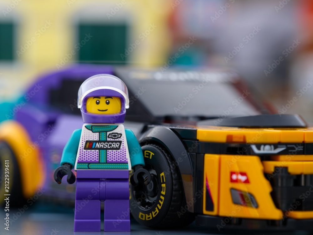 Fototapeta premium Tambov, Russian Federation - January 02, 2026 Portrait of Lego NASCAR Next Gen Chevrolet Camaro ZL1 driver minifigure with his car. LEGO Speed Champions.
