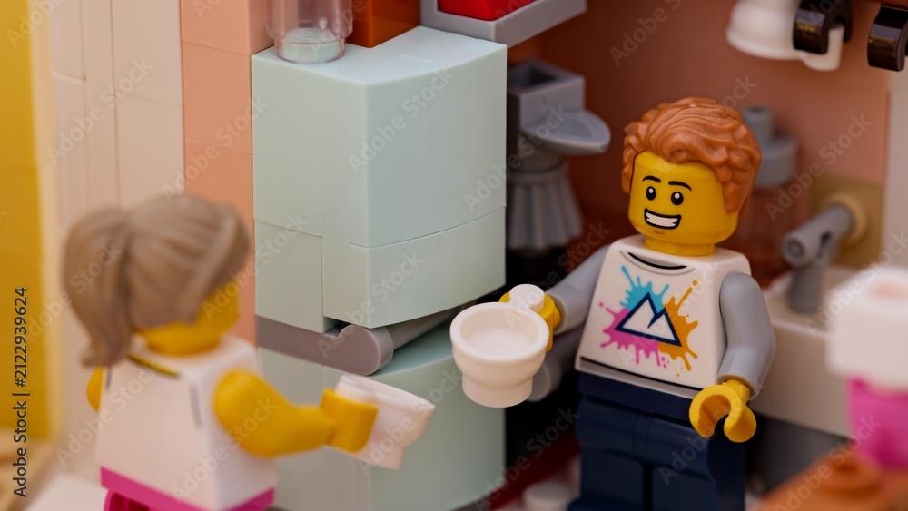 Fototapeta premium Tambov, Russian Federation - January 17, 2026 Close-up shot of Lego man and woman minifigures with empty cups standing in a small kitchen.