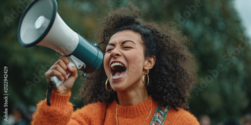 Powerful Young Woman with Megaphone Leads Voice for Change Outdoors