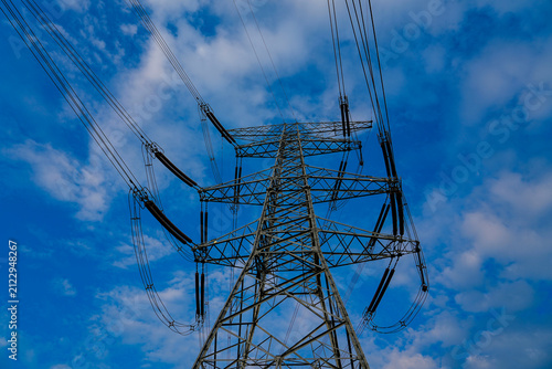 Cuadro en lienzo High voltage transmission tower, power pylon against cloudy blue sky