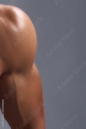 Close-up of a muscular shoulder and arm showing defined deltoid and bicep.