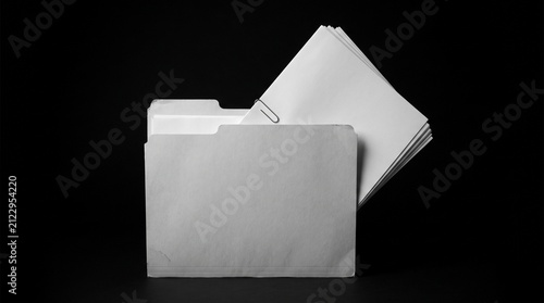 Monochromatic file folder with documents, a classic office organization tool. Essential paperwork management for business and administration, a stack of blank white papers secured with a metal