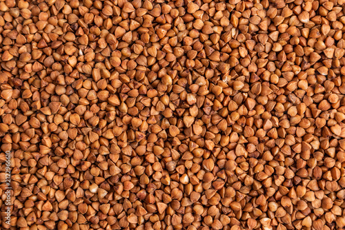 Close-up background of raw buckwheat groat texture