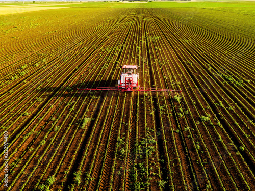 Tractor spraying soybean field aerial view agriculture production