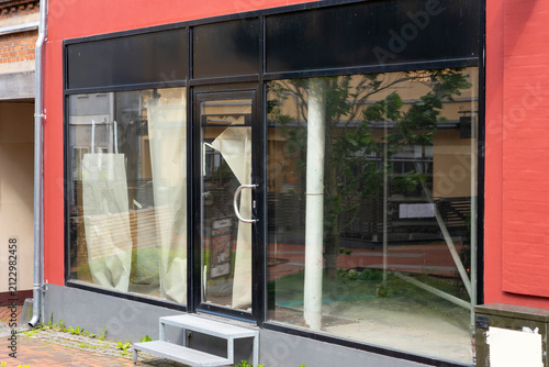 Vacant retail storefront with empty commercial space available for lease in urban shopping district