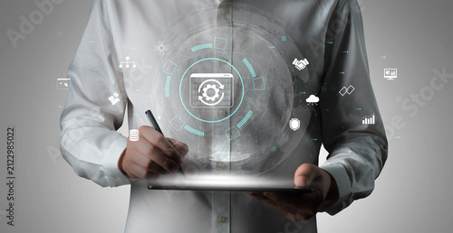 Photography Business professional interacting with digital interface using tablet while analyzing data and technology concepts in modern office environment Quark