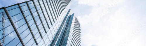 Minimalist composition of contemporary office towers viewed from below in Brussels with generous copy space, emphasizing geometric symmetry, transparent facades and premium corporate real estate