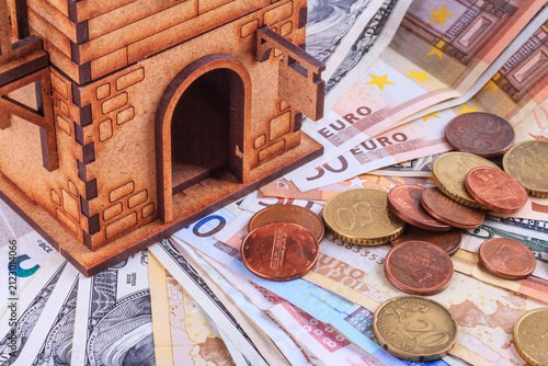 Still life, concept - the investment of money in the purchase and rental housing, taxes, payment, money and a house closeup with selective focus