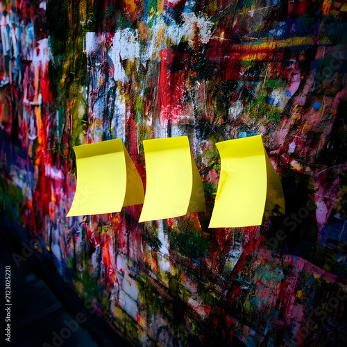 Three blank yellow sticky n...