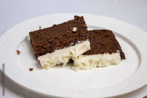 2 slices of plum cake on a large plate against a white background