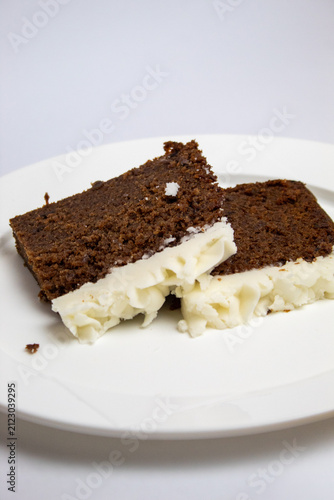 2 slices of plum cake on a large plate against a white background