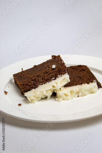 2 slices of plum cake on a large plate against a white background