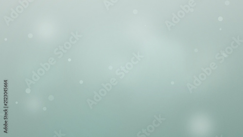 Abstract light blue background with floating particles and soft bokeh effects