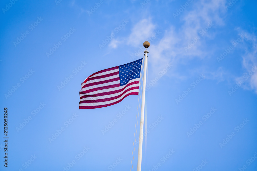 Obraz premium American Flag in Wind with Blue Sky.