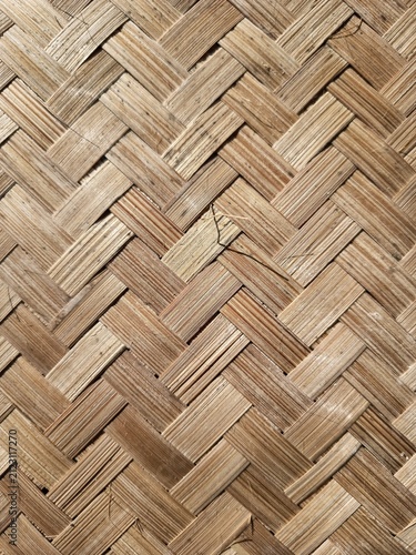 Traditional natural bamboo woven pattern texture in herringbone weave style.