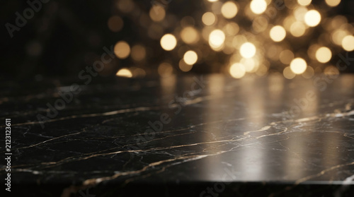 Black marble table top surface with golden veins and warm bokeh lights background