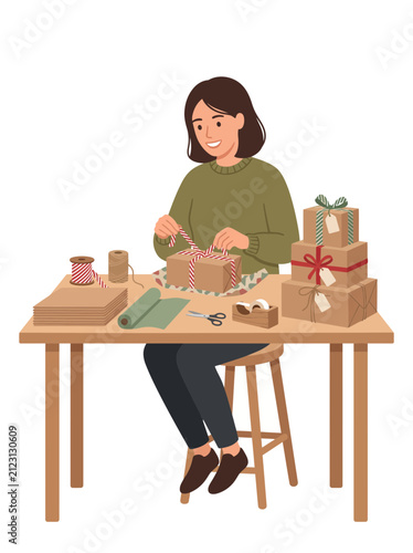Woman happily wrapping gifts at a wooden table with craft supplies