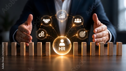 Businessman managing human resources strategy with glowing HR sphere
