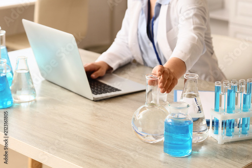 Scientist in lab coat worki...