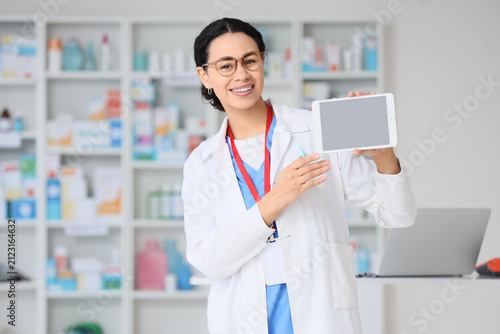 Smiling female pharmacist i...
