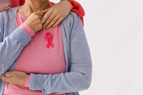 Senior woman with pink ribb...