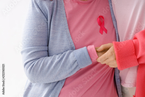 Senior woman with pink ribb...