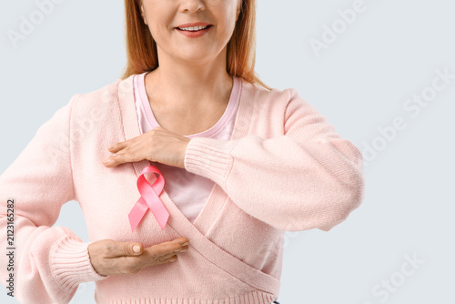 Mature woman with pink ribb...