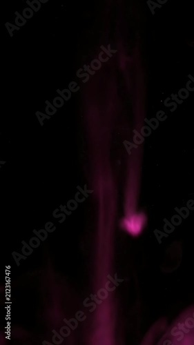 Glowing pink energy trail against black background