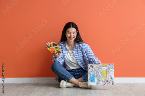 Young woman with painting b...