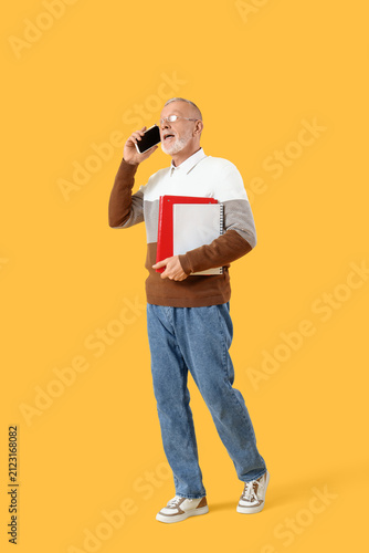 Male teacher with folder ta...