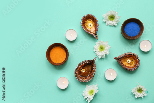 Diya lamps with flowers, ca...