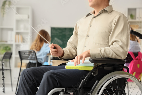 Male teacher in wheelchair ...