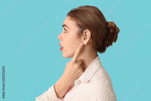 Beautiful young woman point...