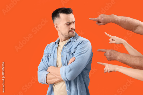 Photography People pointing at young man on orange background