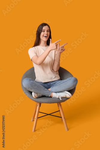 Young woman pointing at som...
