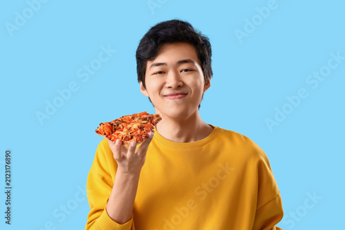 Young Asian man eating tast...