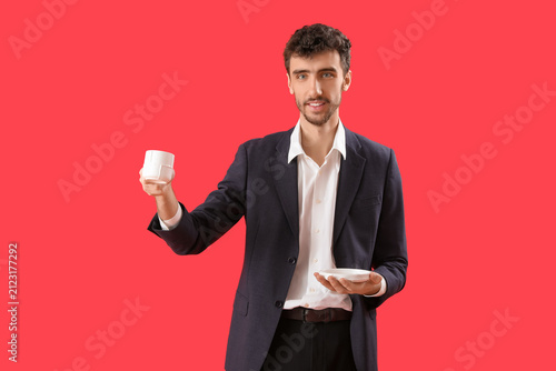 Young man in suit with cup ...