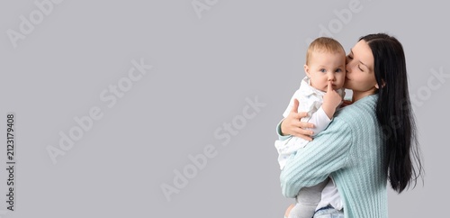 Mother kissing her baby on ...
