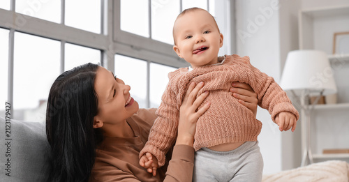 Happy young mother holding ...